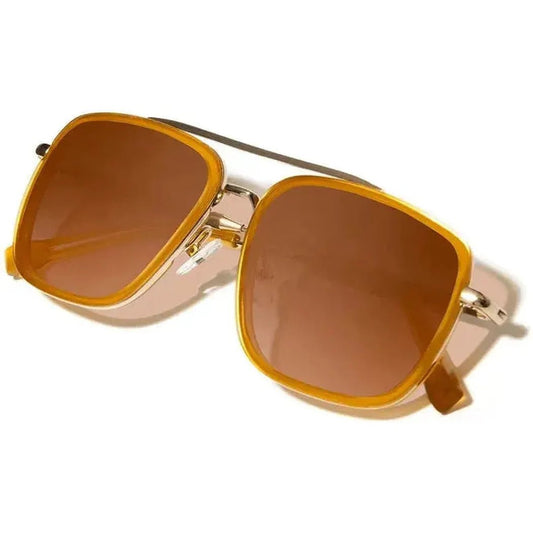 Side view of the Shwood Grant sunglasses with caramel lenses and gold frames against a white background.
