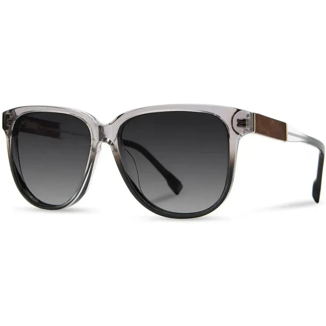 Side view of the Shwood Mckenzie sunglasses in Amethyst with dark lenses and a wooden temple accent against a white background.