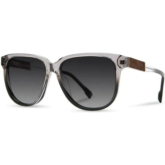 Side view of the Shwood Mckenzie sunglasses in Amethyst with dark lenses and a wooden temple accent against a white background.