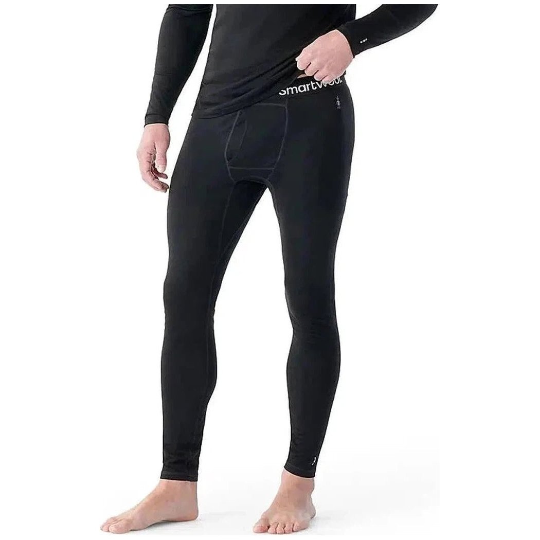 A front view of the black Smartwool Men's Classic All-Season Merino Base Layer Bottom on a barefoot model against a white background.