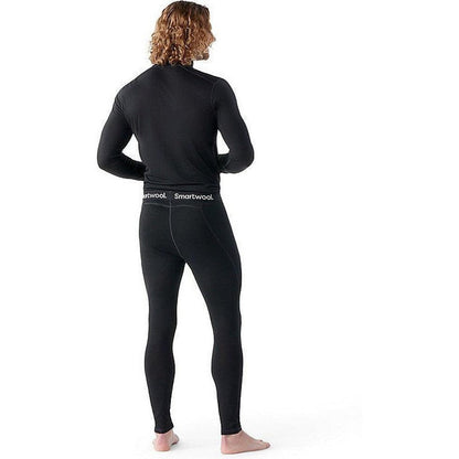 Back view of the Smartwool Men's Classic All-Season Merino Base Layer Bottom in Black on a barefoot model against a white background.