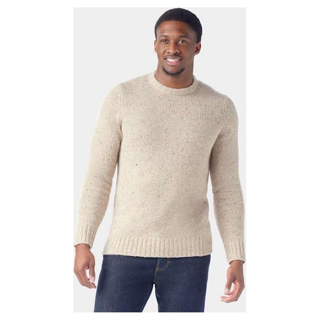 A front view of the Smartwool Men's Heavy Crew Sweater in Oat Heather on a model wearing dark jeans against a plain background.