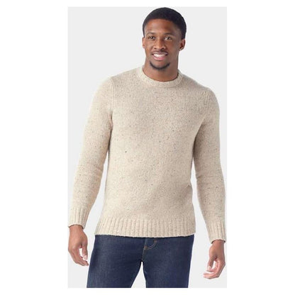 A front view of the Smartwool Men's Heavy Crew Sweater in Oat Heather on a model wearing dark jeans against a plain background.