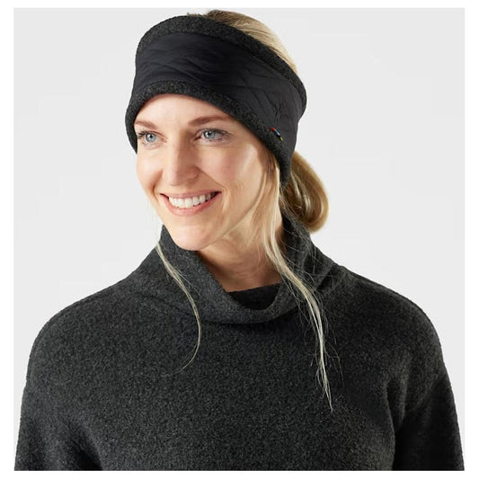 A woman wearing the black Smartwool Quited Fleece Headband in a front view against a white background.
