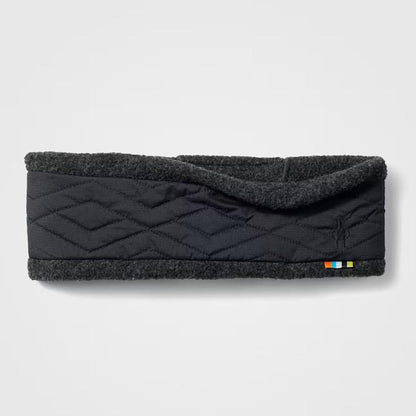 A front view of the Smartwool Quited Fleece Headband in Black with a quilted design and a small colorful tag on the bottom right, against a plain white background.