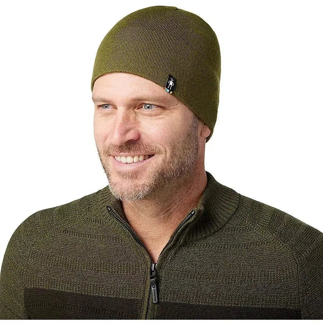 A man wearing the Smartwool The Lid in Winter Moss is shown from the front against a white background.