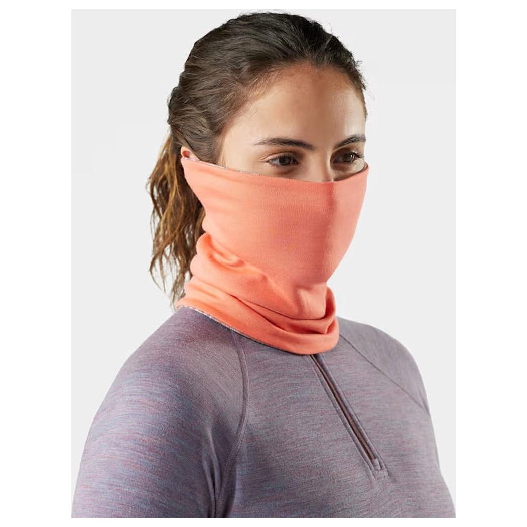A woman wears the Smartwool Thermal Reversible Neck Gaiter in Black/Black, shown from the front with a plain background.