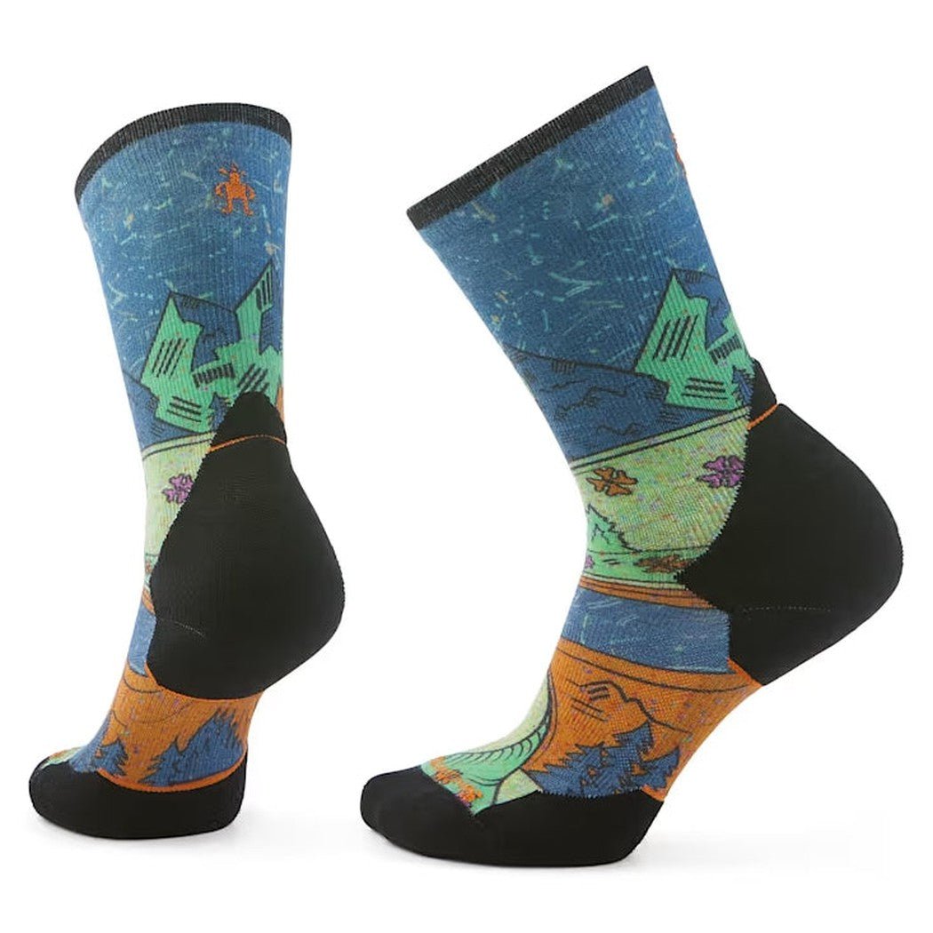 Side view of the Smartwool Women's Trail Run Targeted Cushion Mountain Print Crew Socks in Twilight Blue showing the mountain print and black heel and toe against a white background.
