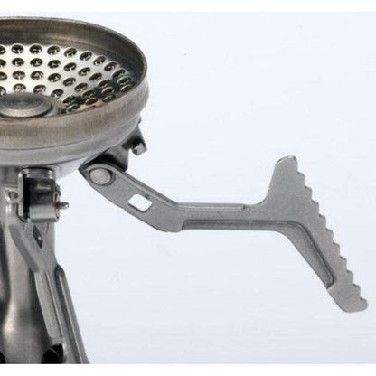 A close-up of the Soto Outdoors Amicus without Igniter stove showing its metallic burner and serrated adjustment lever against a plain white background.