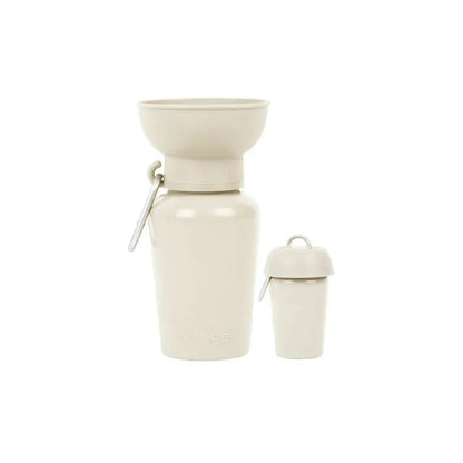 A side view of the black Springer Flip Dog Travel Bottle showing the flip-top lid and attached carabiner against a white background.
