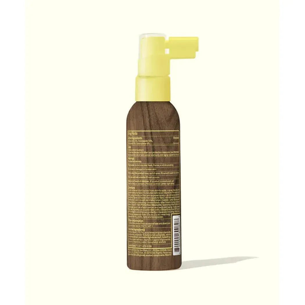 Back view of the Sun Bum SPF 30 Protecting Scalp & Hair Mist with a yellow pump against a light background.
