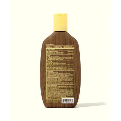 Back view of the Sun Bum SPF 30 Sunscreen Lotion bottle with yellow cap against a white background.
