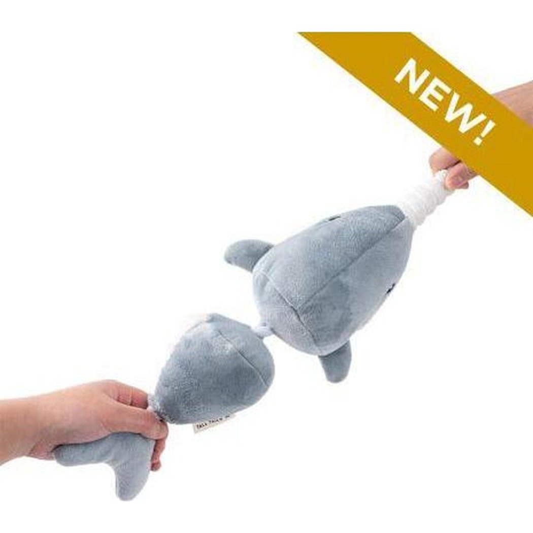 Two hands hold a gray Tall Tails Narwhal Jointed Shake Play Dog Toy against a white background with a yellow "NEW!" banner.