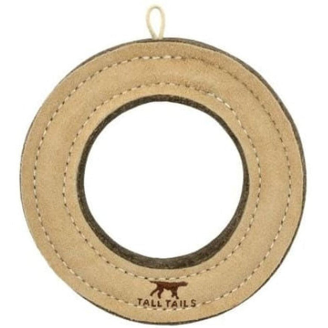 A natural leather ring toy from Tall Tails with a hanging loop and a dog logo at the bottom.