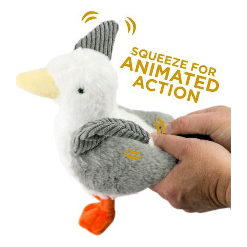 A hand squeezes the Tall Tails Plush Seagull Animated Wing Toy, showing its gray and white body, orange feet, and squeeze feature against a white background.