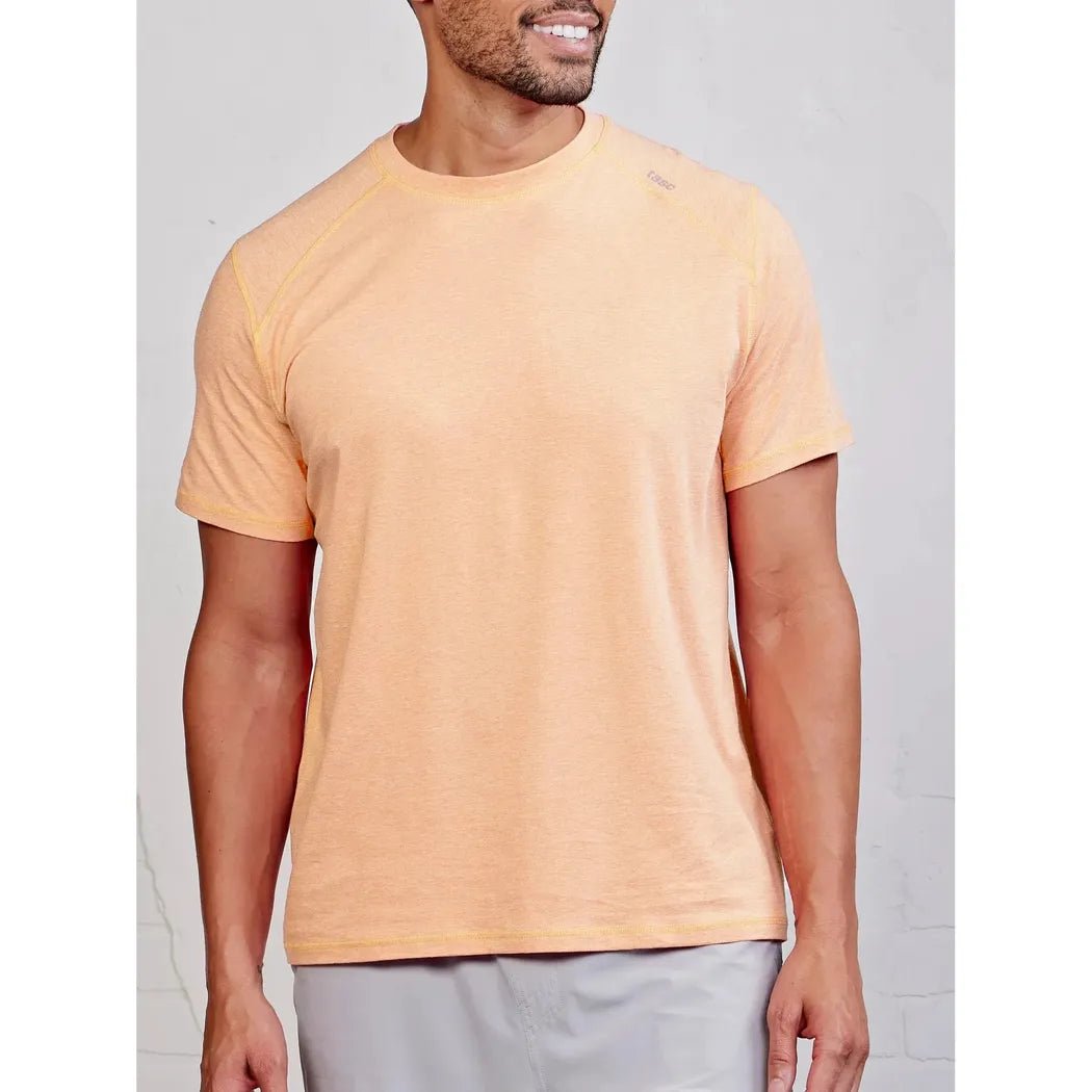 A front view of the Tasc Men's Carrollton T in Anchor color on a model wearing light gray shorts against a light gray background.