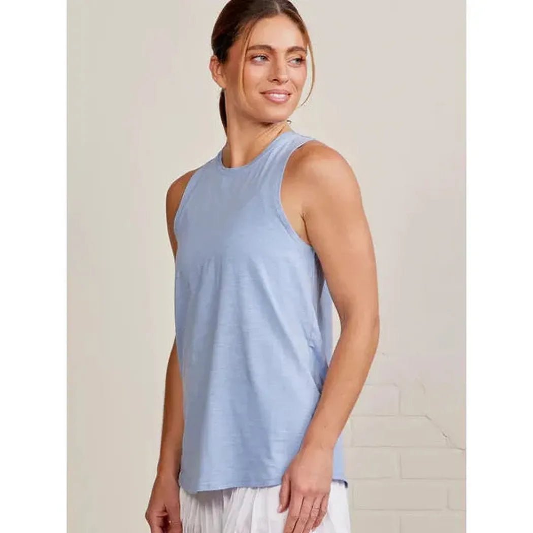 Side view of the Tasc Women's Nola Tank 2.0 in Heritage Blue showing the sleeveless design on a model against a light background.