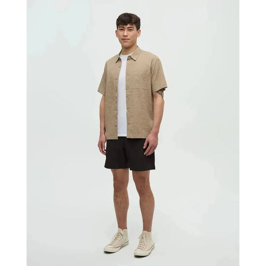 A model wearing the Tentree Men's Redwood Pocket Shirt in Khaki/Palm stands against a plain white background.