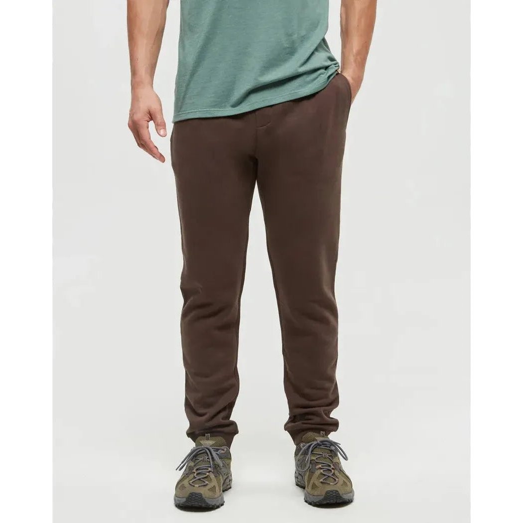 A front view of the Tentree Men's TreeFleece Atlas Sweatpant in Kona, showing the model wearing them with a plain white background.