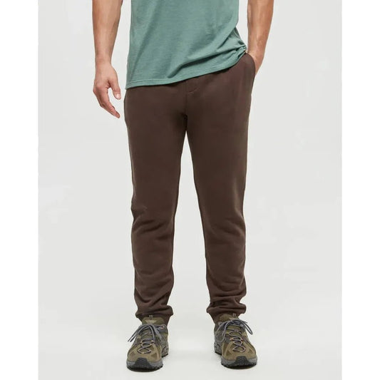 A front view of the Tentree Men's TreeFleece Atlas Sweatpant in Kona, showing the model wearing them with a plain white background.