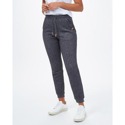 Side view of the Tentree Women's Bamone Sweatpant in Meteorite Black Marled with drawstring waist and cuffed ankles, model wearing white sneakers against a plain white background.