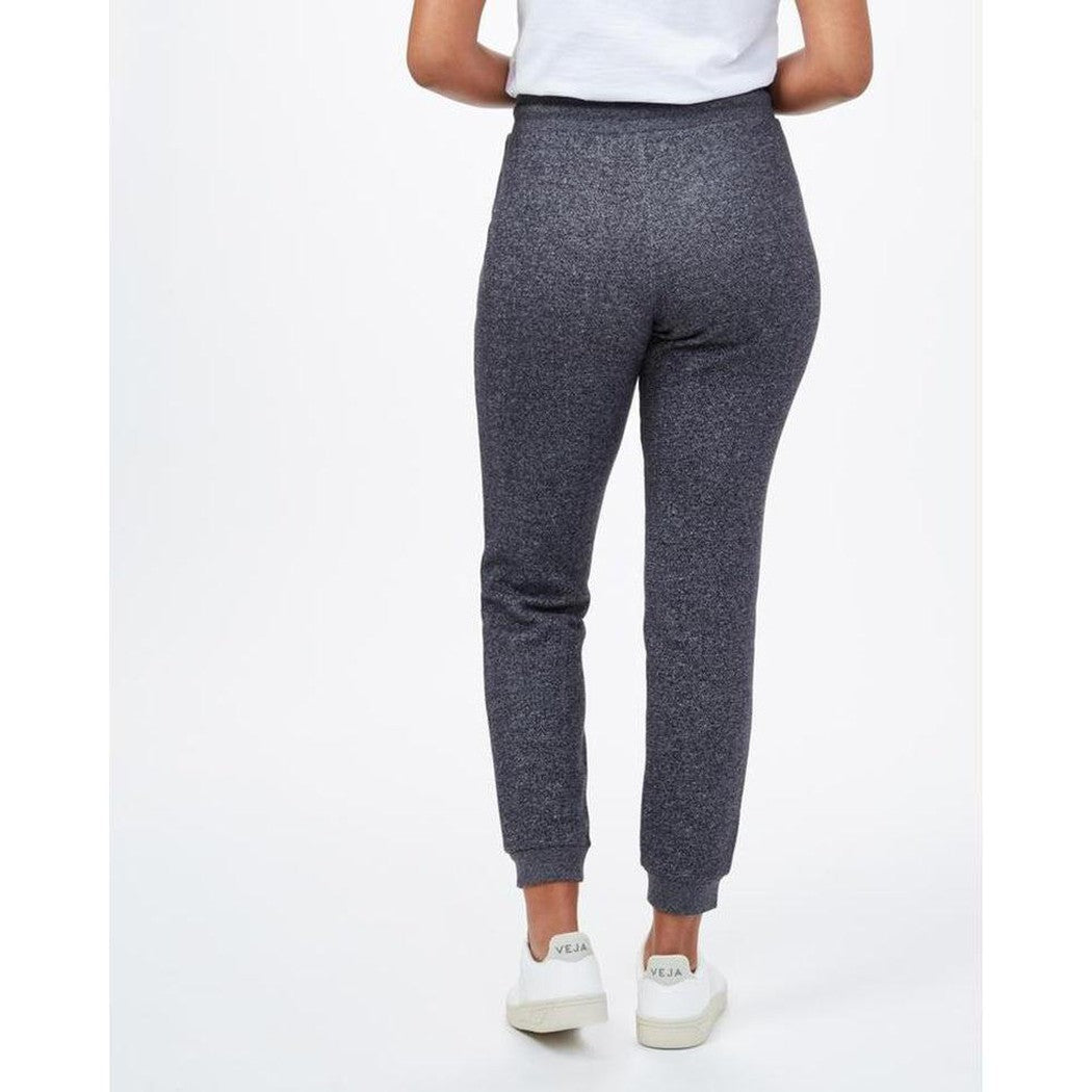 Back view of the Tentree Women's Bamone Sweatpant in Meteorite Black Marled on a model wearing white sneakers against a white background.