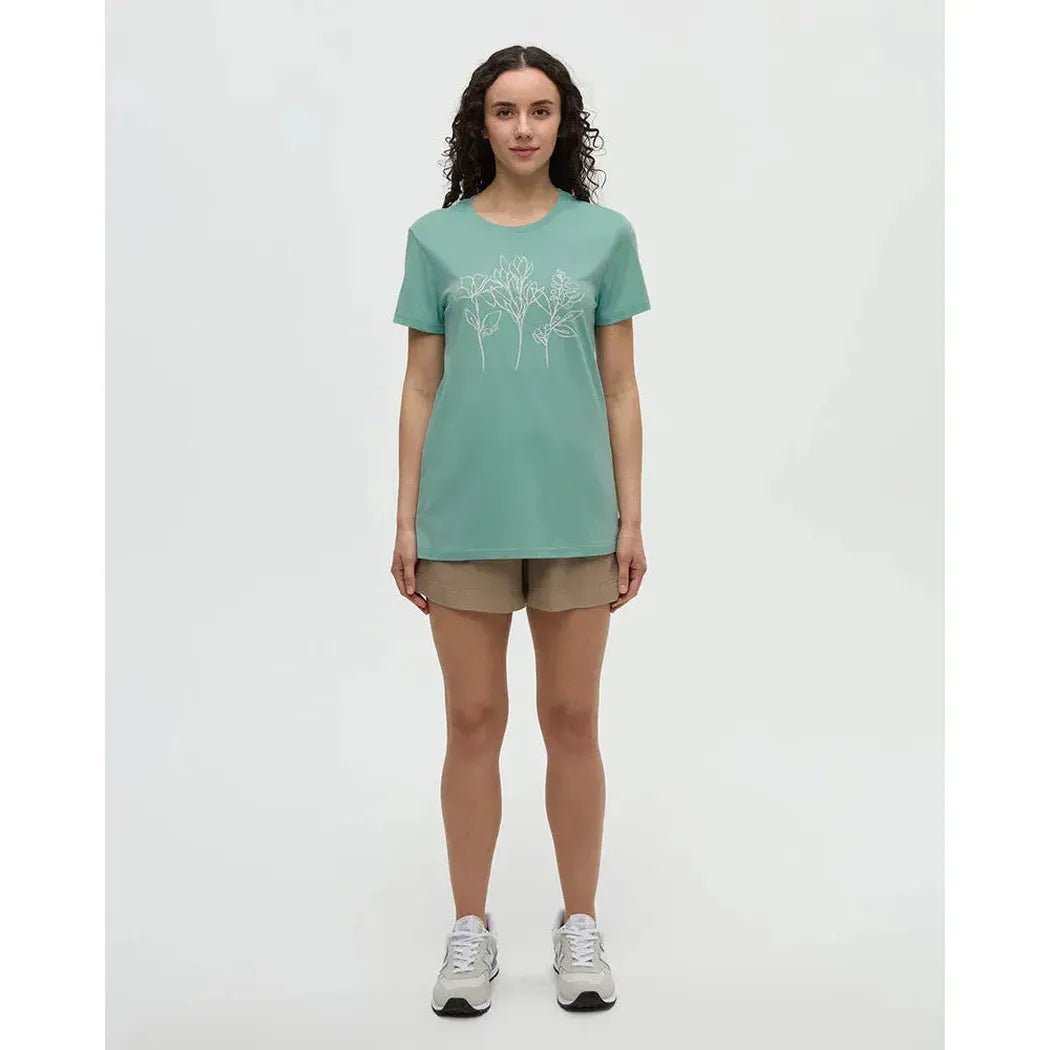 A model wearing the Tentree Women's Cummer Flora T-Shirt in Turquoise Sky Vintage White stands against a white background.
