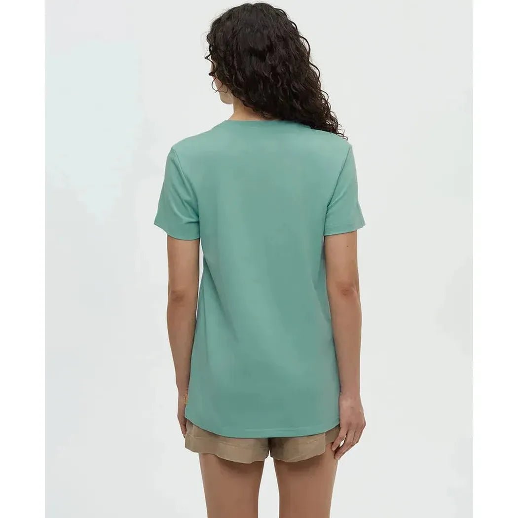 Back view of the Tentree Women's Cummer Flora T-Shirt in Turquoise Sky Vintage White on a model wearing khaki shorts against a plain white background.
