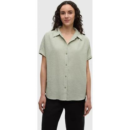 A model wears the Tentree Women's Magnolia Shirt in Light Moss against a plain white background.