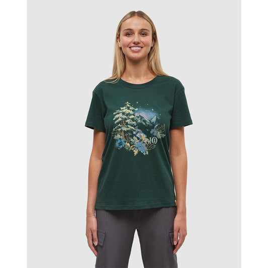 A woman wearing the Tentree Women's Regenerative Forest Sprawl T-Shirt in Forest Pine Granite Green stands against a plain white background.