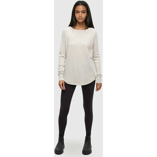 A front view of the Tentree Women's Storey Longsleeve in Vintage White Heather on a model wearing black leggings and boots against a plain background.