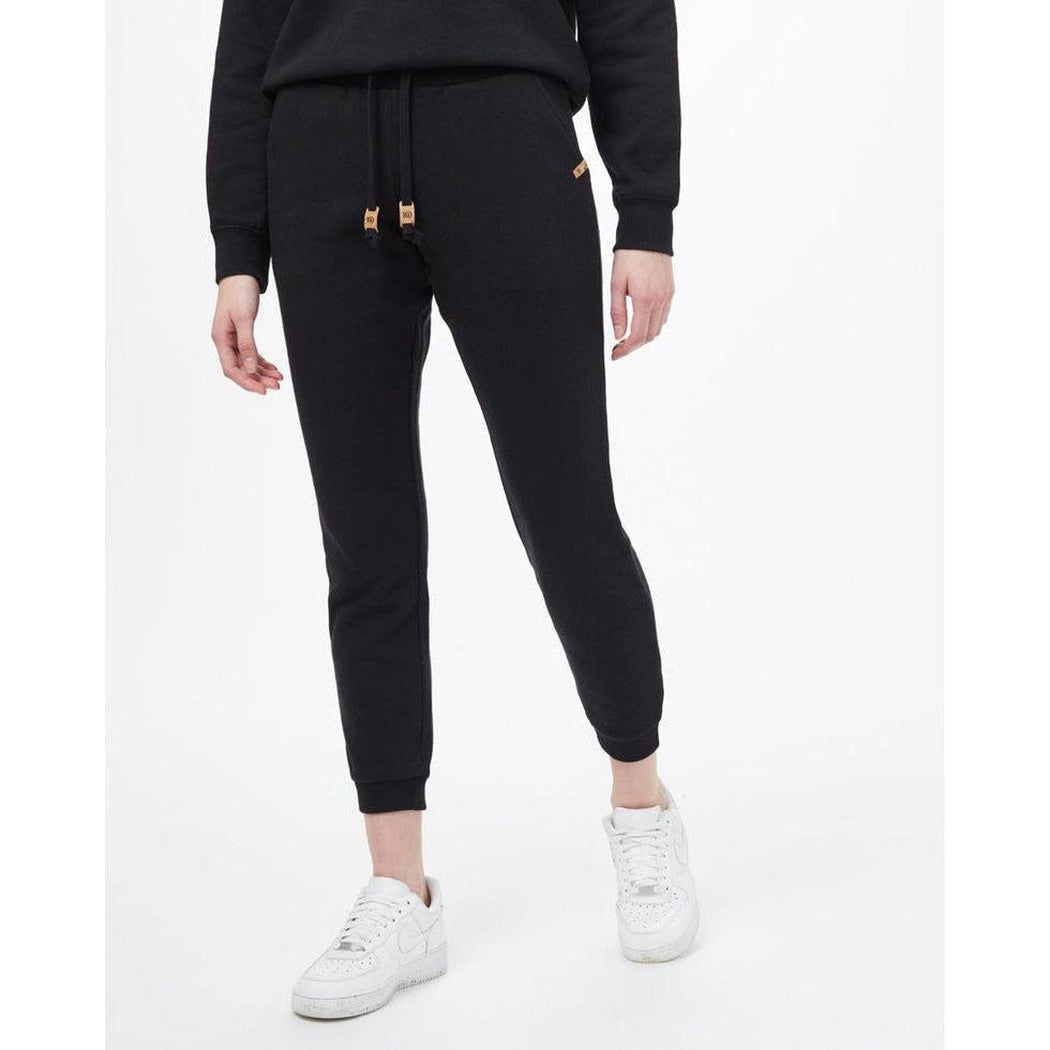 A front view of the Tentree Women's TreeFleece Bamone Sweatpant in Meteorite Black on a model wearing white sneakers against a white background.