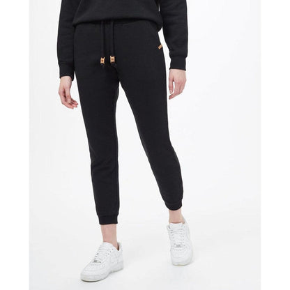 A front view of the Tentree Women's TreeFleece Bamone Sweatpant in Meteorite Black on a model wearing white sneakers against a white background.