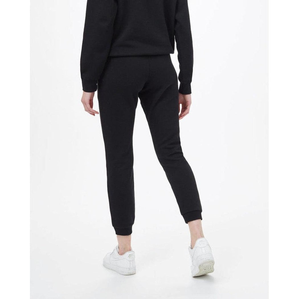 Back view of the Tentree Women's TreeFleece Bamone Sweatpant in Meteorite Black on a model wearing white sneakers against a white background.
