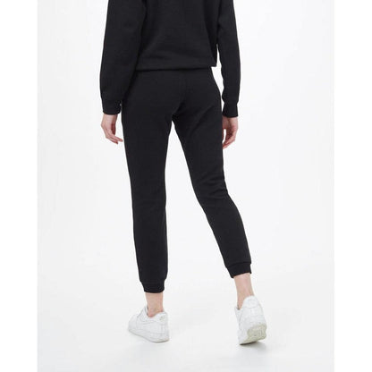 Back view of the Tentree Women's TreeFleece Bamone Sweatpant in Meteorite Black on a model wearing white sneakers against a white background.