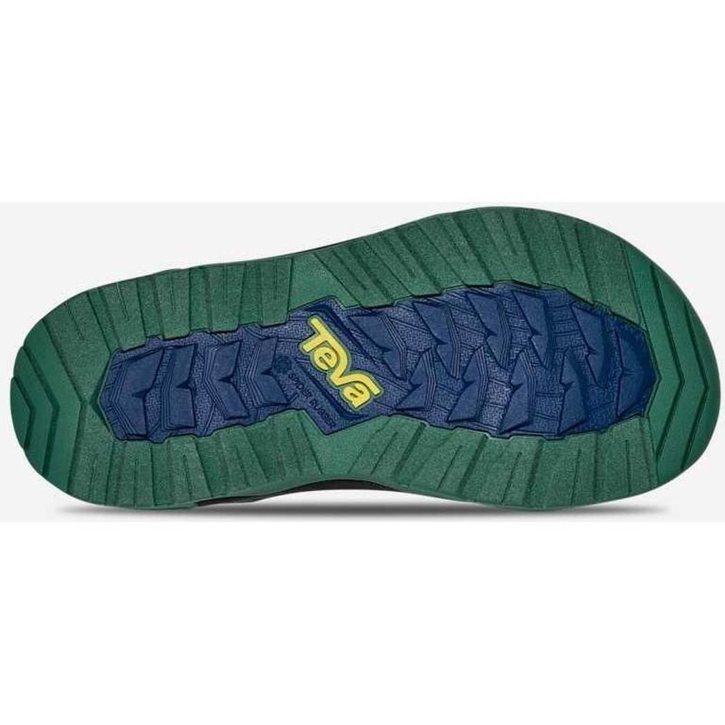 The sole of a Teva Kid's Hurricane XLT JR shoe shows a blue and green tread pattern with the brand name in yellow, viewed from below against a white background.