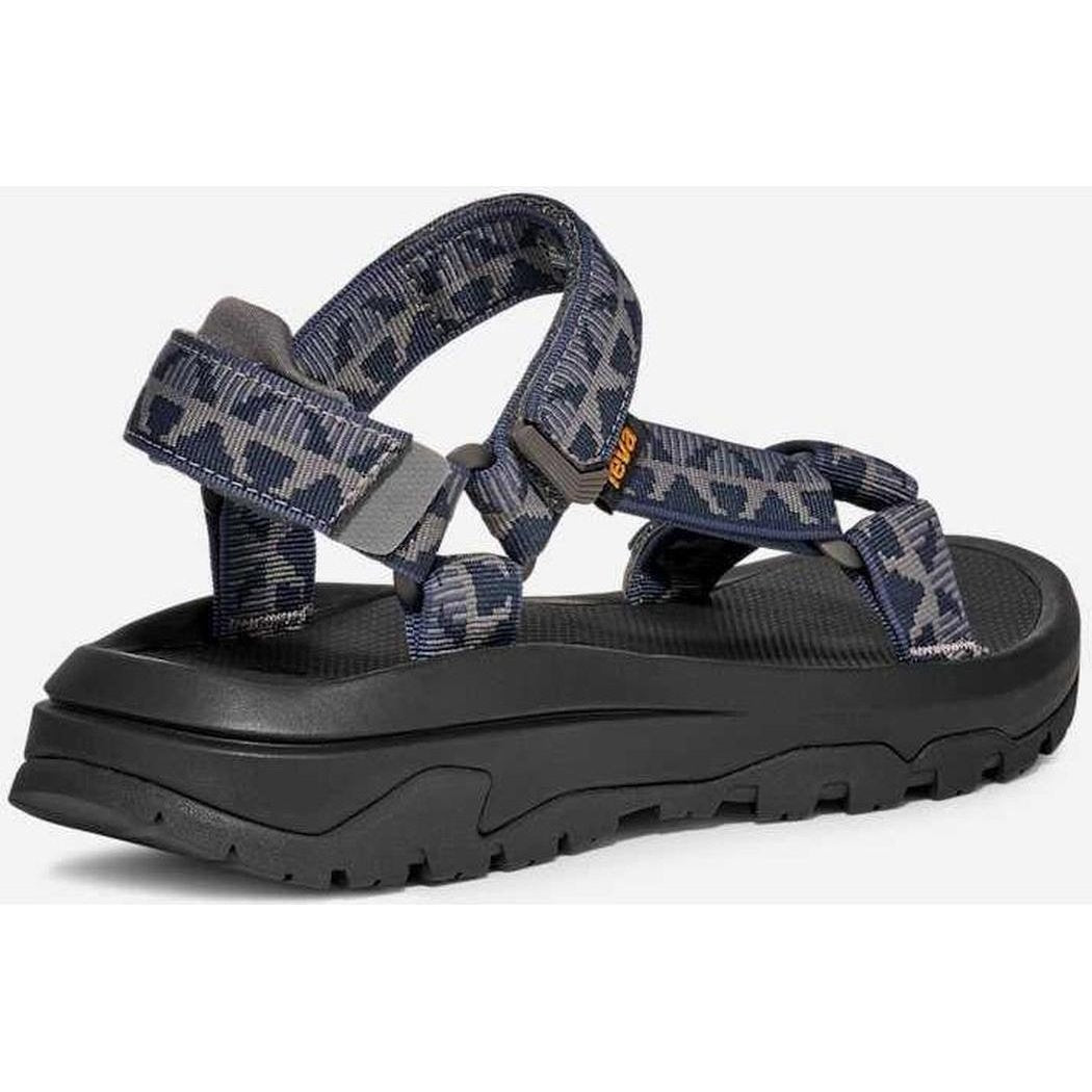 Side view of the Teva Men's Hurricane XLT3 in Criss Cross Navy/ Grey showing the thick lugged outsole against a white background.