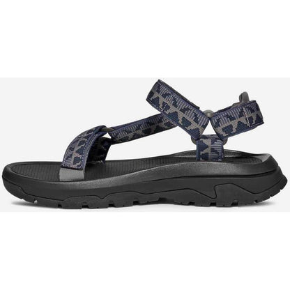Side view of the Teva Men's Hurricane XLT3 in Criss Cross Navy/ Grey showing the adjustable straps and thick treaded sole against a white background.
