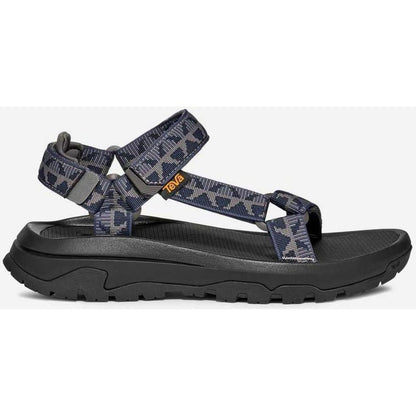 Side view of the Teva Men's Hurricane XLT3 in Criss Cross Navy/ Grey showing the thick lugged outsole against a white background.