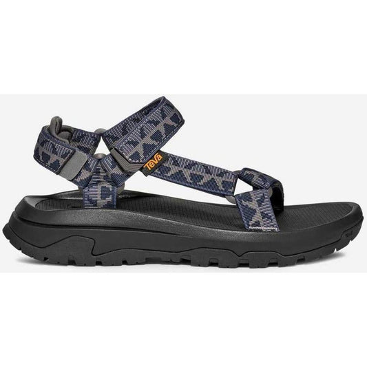 Side view of the Teva Men's Hurricane XLT3 in Criss Cross Navy/ Grey showing the thick lugged outsole against a white background.