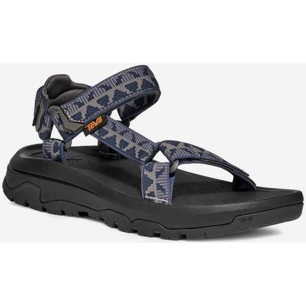 Side view of the Teva Men's Hurricane XLT3 in Criss Cross Navy/ Grey showing the crisscross strap pattern and thick lugged outsole against a white background.