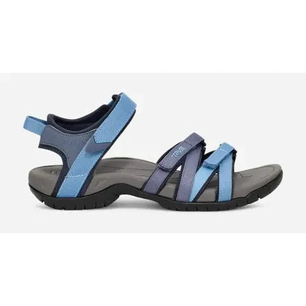 Side view of the Teva Women's Tirra in Black/Grey showing the adjustable straps and cushioned footbed against a white background.