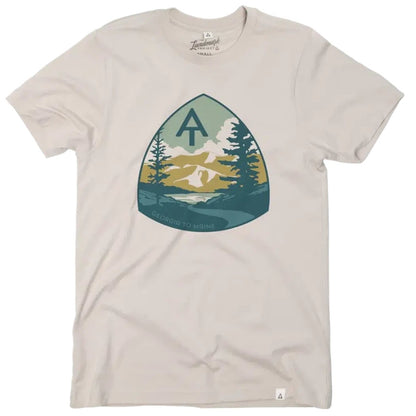 A beige The Landmark Project Appalachian Trail Tee with a triangular graphic of mountains, trees, and a tent logo on the front.