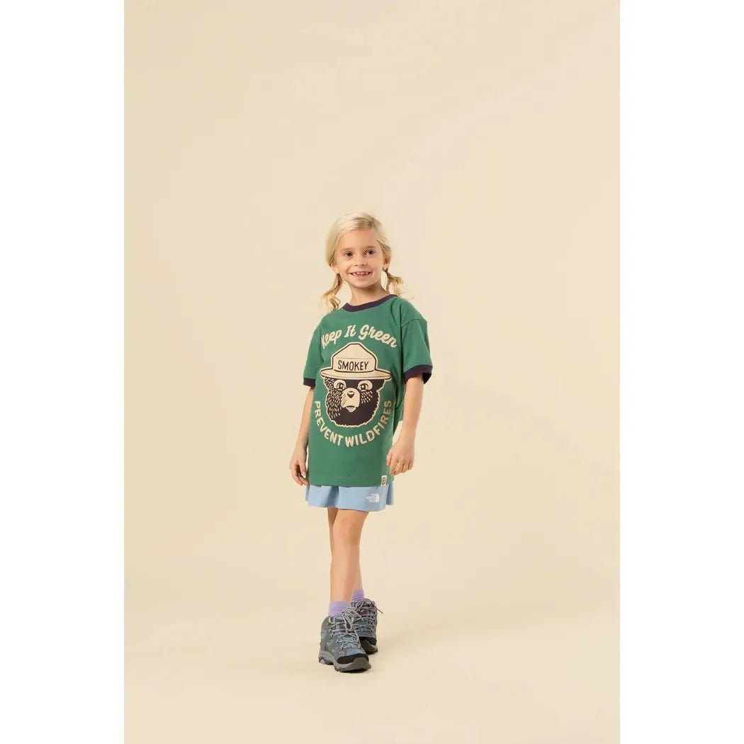 A front view of The Landmark Project Keep It Green Youth Short Sleeve Ringer Tee in Palm Leaf/Dusk on a model against a neutral background.
