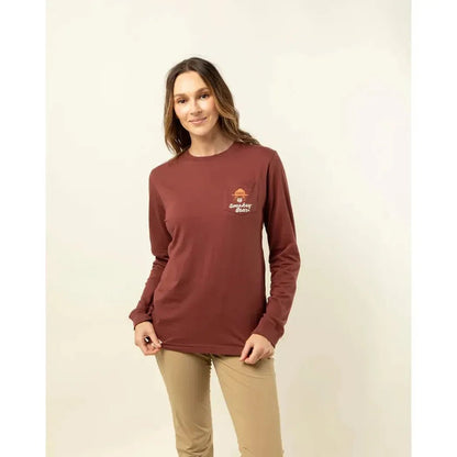 A woman wearing The Landmark Project Spark A Change Unisex Long Sleeve Tee w/ Pocket in Angostura stands against a plain background.