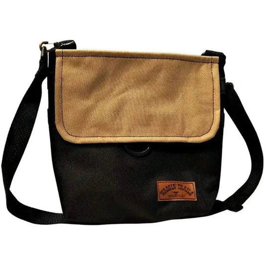 A front view of the Black/Tan The WoofPack Dog Walking Accessory Bag showing the shoulder strap and logo patch against a white background.