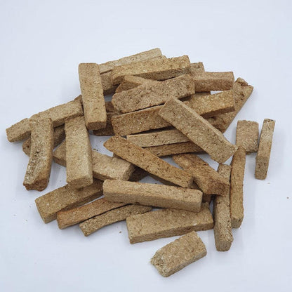 A pile of brown Tickled Pet Cod Snacks 10oz treats on a white background.