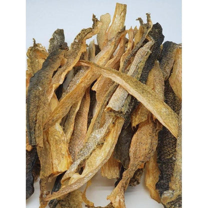 Dried salmon skins from Tickled Pet Salmon Skins 6oz Bag, showing their natural texture and varied brown tones against a plain white background.