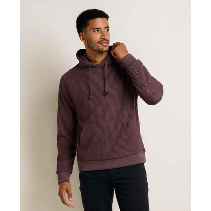 A front view of the Toad & Co Men's Bitterroot Long Sleeve Hoodie in Raisin on a model against a plain background.