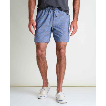 A front view of the Toad & Co Men's Boundless Pull-On Short in Raisin Tonal Print on a model wearing white sneakers against a plain background.